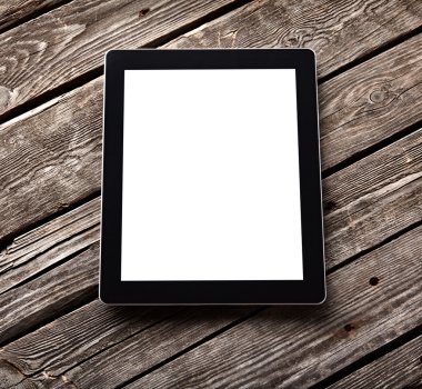 Eski ahşap masa üzerinde dijital tablet