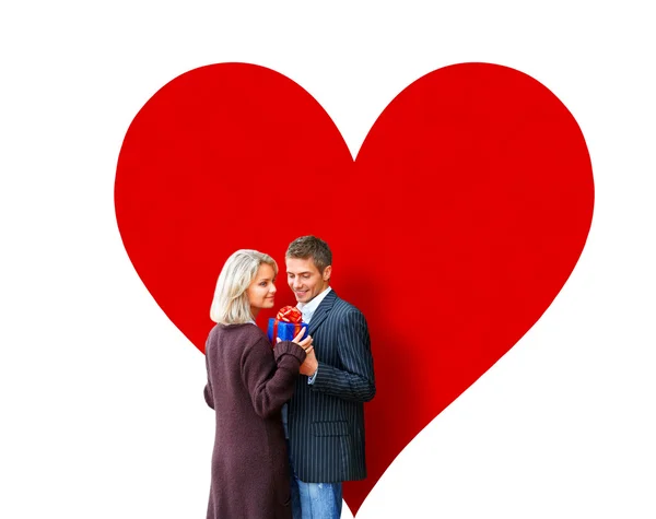 Couple embracing on red heart background — Stock Photo, Image