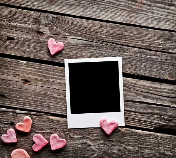 Instant photo and red hearts — Stock Photo, Image