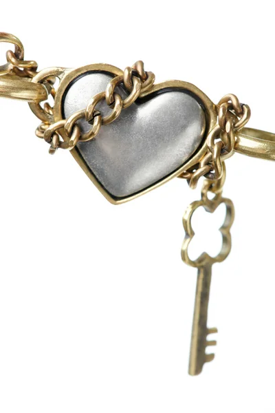 Metallic heart shape and metal key — Stock Photo, Image