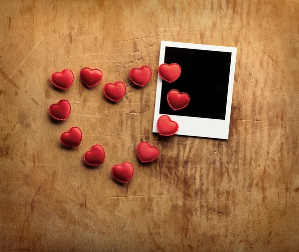 Instant photo and small red hearts — Stock Photo, Image
