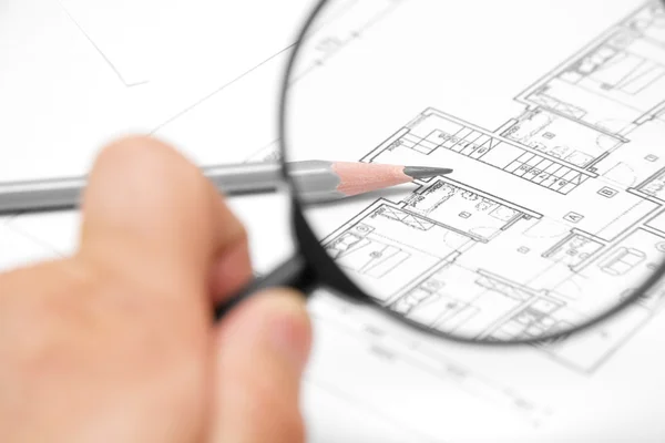 Architectural blueprint and magnifying glass — Stock Photo, Image