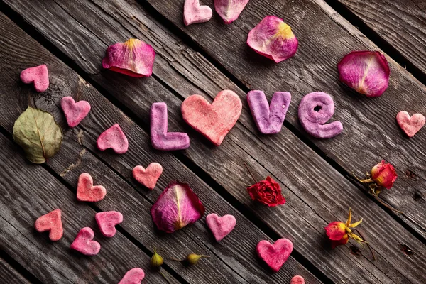 Palabra Amor con pétalos de rosa —  Fotos de Stock