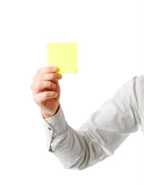 Yellow note paper in man's hand — Stock Photo, Image