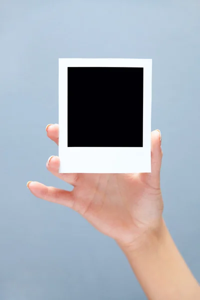 Instant photo in hand — Stock Photo, Image