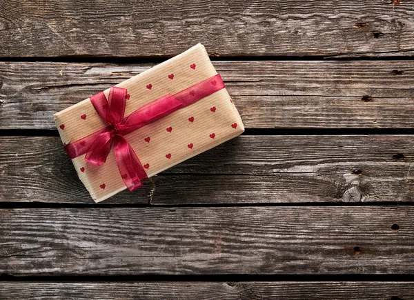 Gift box tied red ribbon — Stock Photo, Image