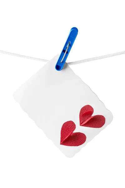 Card with two hearts hanging on clothesline — Stock Photo, Image