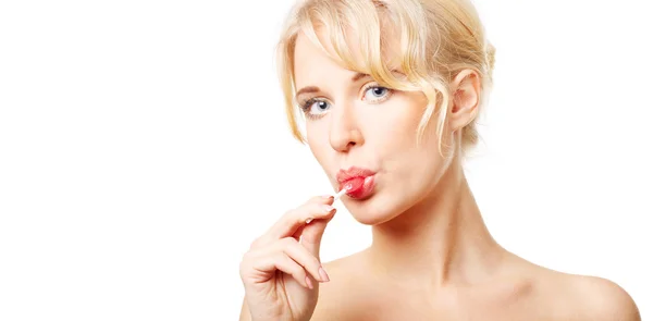 Blond woman sucking lollipop — Stock Photo, Image