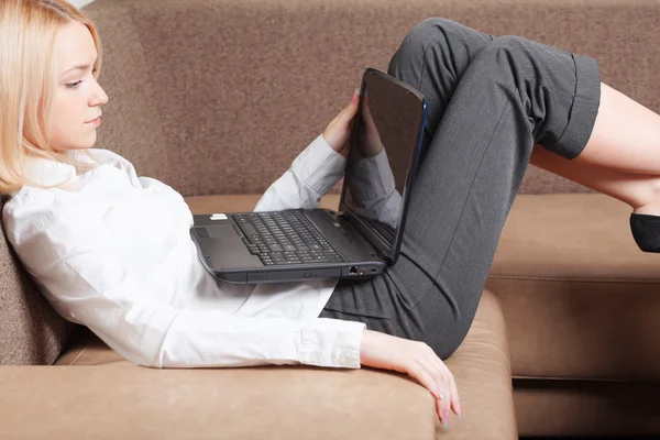 Businesswoman with laptop on sofa Stock Picture