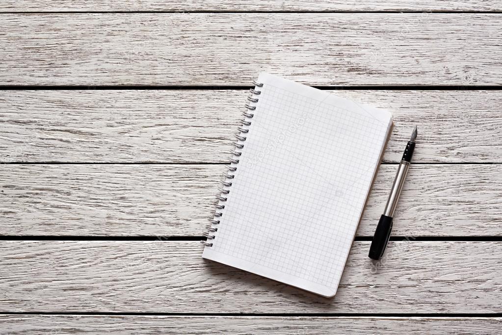 Blank notepad with a pen