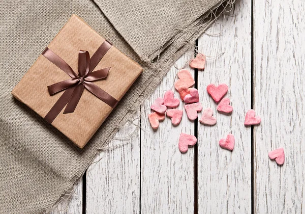 Gift box with heap of small hearts — Stock Photo, Image