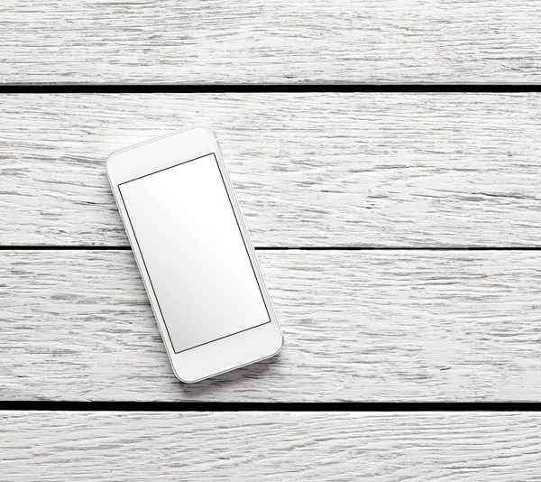 White smart phone on white wooden desk — Stock Photo, Image