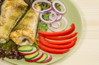 Baked shad with vegatables at dish