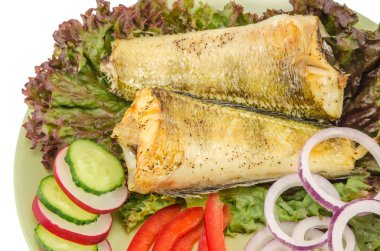 Baked shad with vegetables at dish