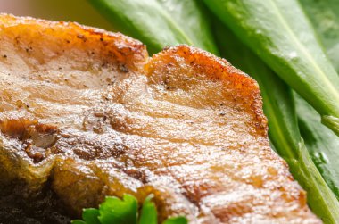 Grilled carp at lilac plate close up