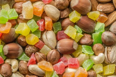 Group of different nuts and candied fruits isolated on bagging