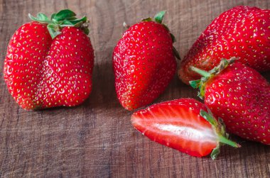 Ripe organic juicy strawberry on wooden table