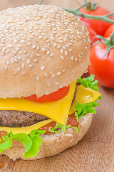 Tasty cheeseburger with lettuce, beef, double cheese and ketchup. Macro with shallow focus. — Stock Photo, Image