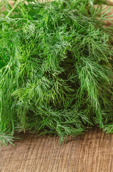 Green ripe organic dill on wooden background — Stock fotografie