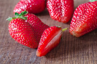 Ripe organic juicy strawberry on wooden table shallow focus
