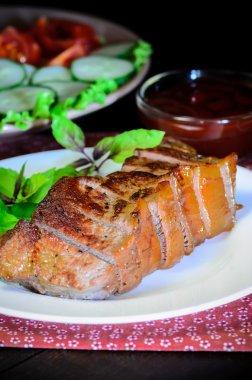 Grilled beef steak with salad and sauce on wooden table