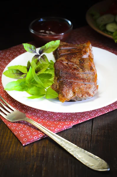 Grilled beef steak with salad and sauce on wooden table — Stock Fotó