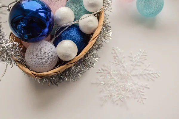 Blue and white Christmas trees in a basket next to it lies a snowflake — Stock Photo, Image