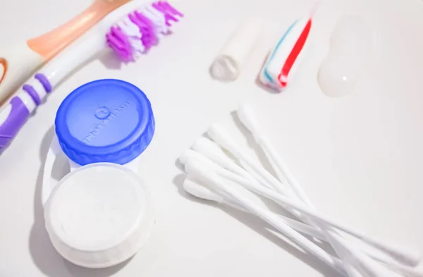 Hygiene toothbrushes, a container for lenses and earplers — Stock Photo, Image