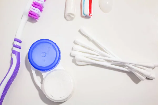 Hygiene toothbrushes, a container for lenses and earplers for care — Stock Photo, Image