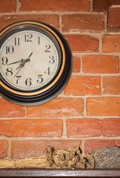 Γύρω όμορφα ρολόγια κρέμονται σε έναν τοίχο από τούβλα σε ένα ρουστίκ φούρνο — Φωτογραφία Αρχείου