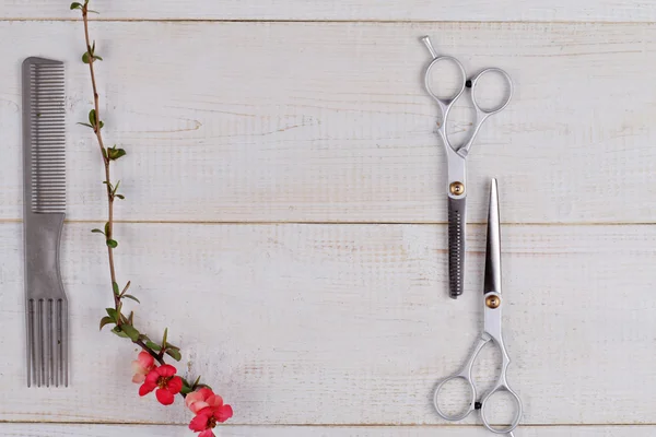 Stylish Professional Hair Cutting and Thinning Scissors on wooden background. Hairdresser salon concept. Haircut accessories, flat lay