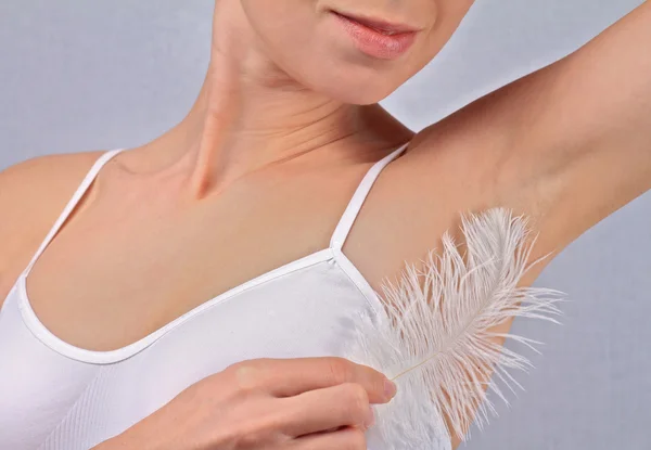 Armpit waxing, laser hair removal. Young woman holding her arms up and showing underarms, armpit, ideal smooth clear skin — 스톡 사진