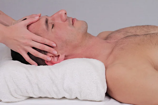 Muž požívající tvář masáž hlavy. Relaxace, lázeňská léčba, wellness koncepce — Stock fotografie