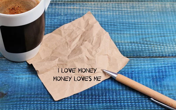 Money attraction affirmation. I love money money loves me. Inspirational motivating quote on retro paper and coffee. Wealth, success concept
