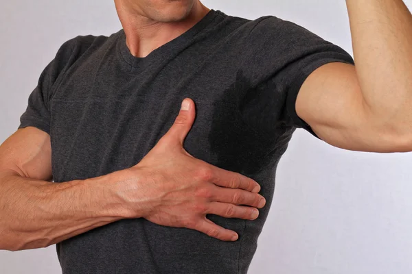 Sport man armpit sweating. Transpiration stain. Hyperthyroidism concept — Stock Photo, Image
