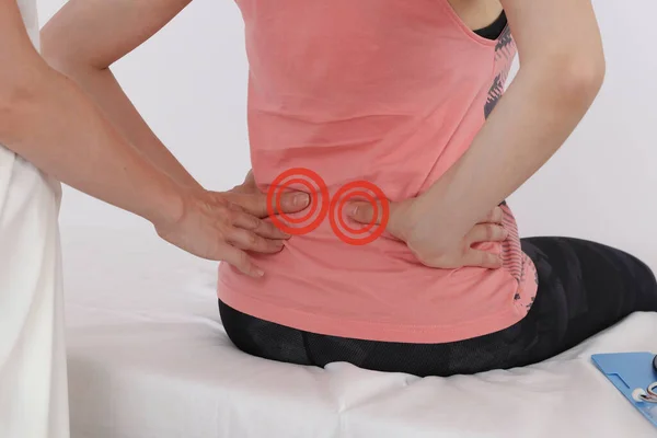 Pregnancy Low back pain relief concept. Chiropractic, Osteopathy, Physiotherapy.