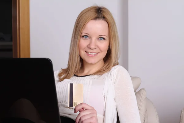 An attractive young women with laptop and credit card
