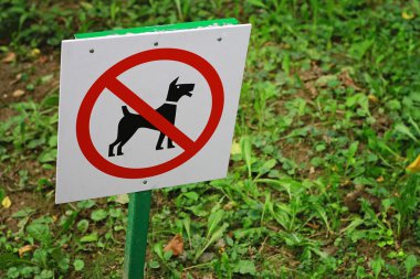 Sign dogs are not allowed in park , outdoors
