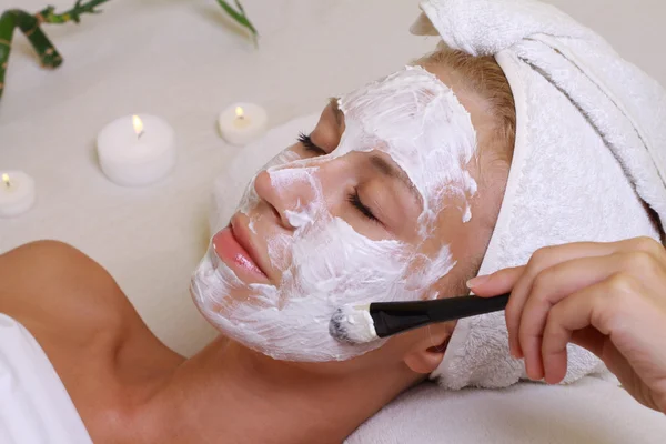 Junge schöne Mädchen erhalten Gesichtsmaske im Wellness-Schönheitssalon. Hautpflege, Schönheitsbehandlungen. — Stockfoto