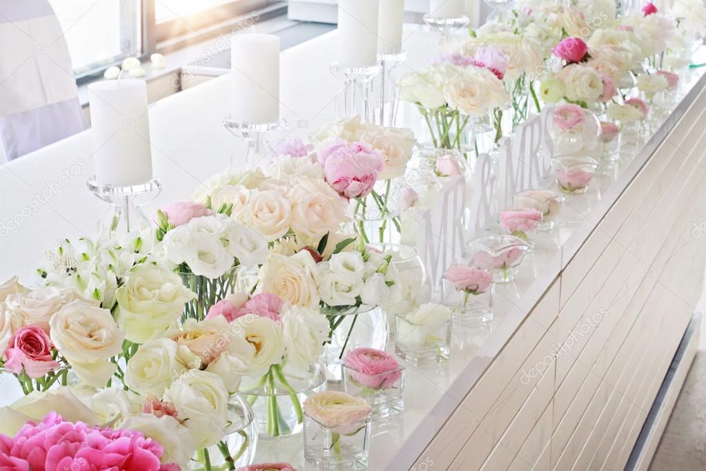 Wedding table decoration.  Ranunculus, roses, candels