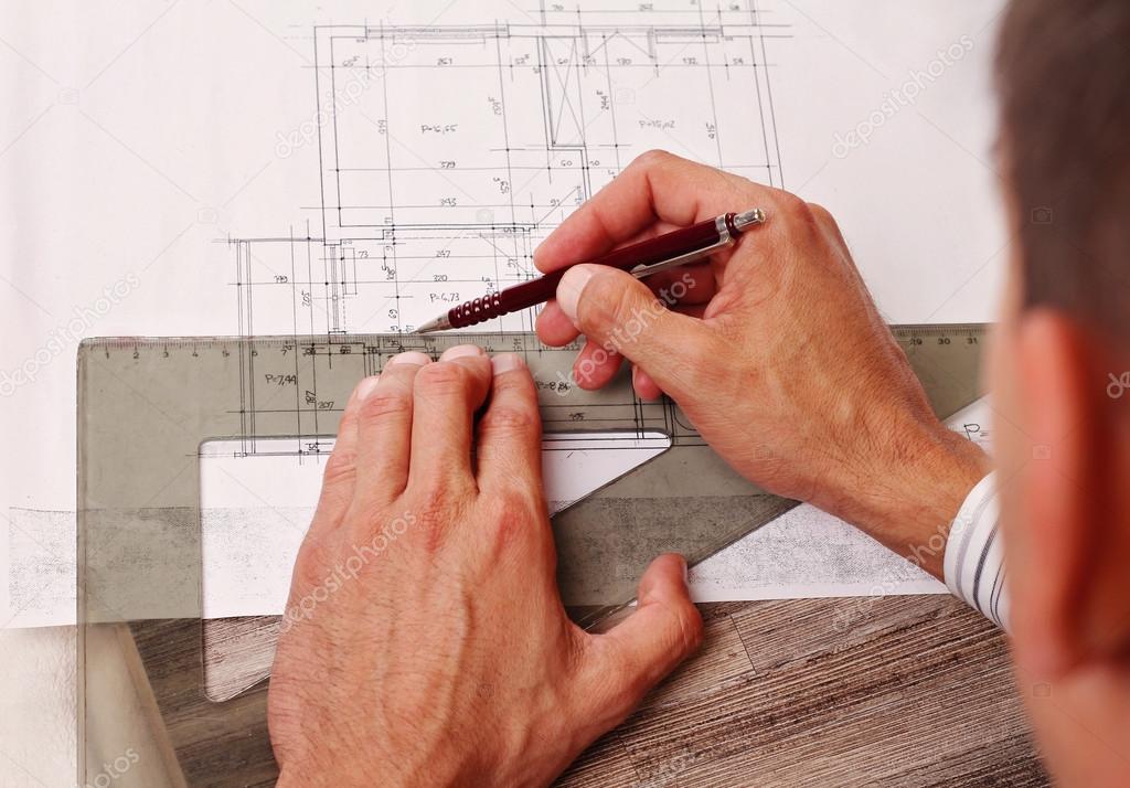 Close up on Architect drawing a construction project (plan, compass,house )