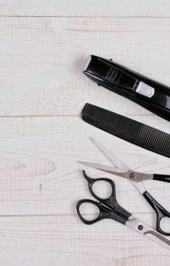 Scissors and   on white rustic wooden background. Hairdresser salon concept. Haircut  accessories