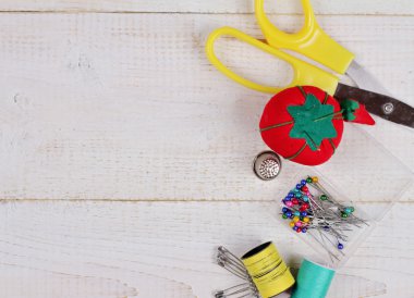 Sewing thread, accessories on white background.Needles, Bobbins, Buttons, Shears, Pins. Hobby, needlework, dressmaking concept