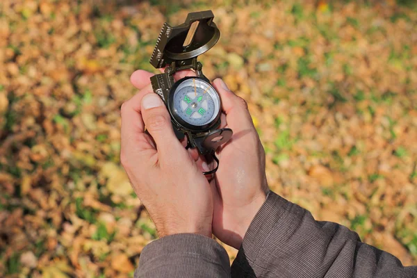 Man using compass in nature or autumn forest. Close up of hands — 스톡 사진