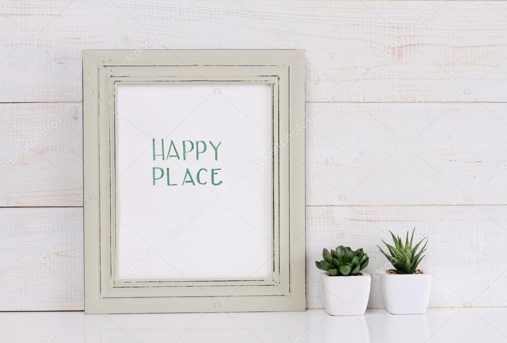 Home and family  and happiness concept. Happy place poster in frame rustic , shabby chic, vintage style. Scandinavian style home interior decoration.