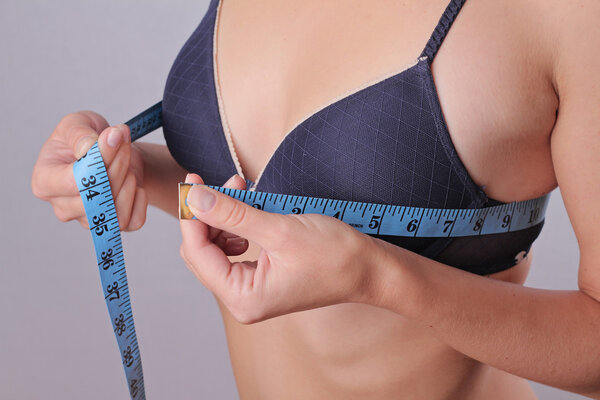 Woman measuring her breast size.
