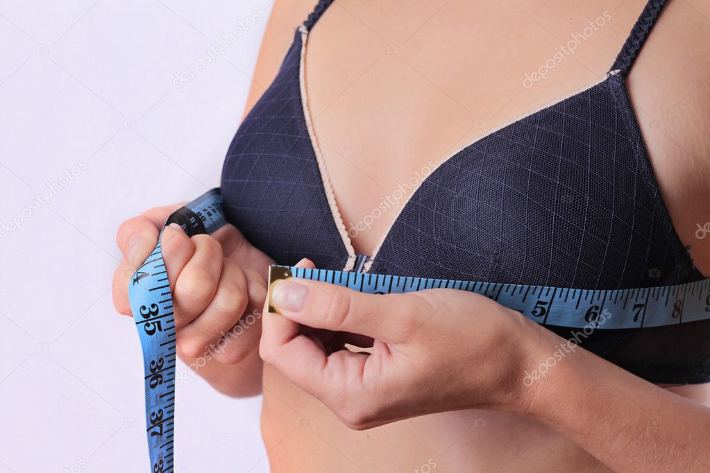 Woman measuring her breast size.