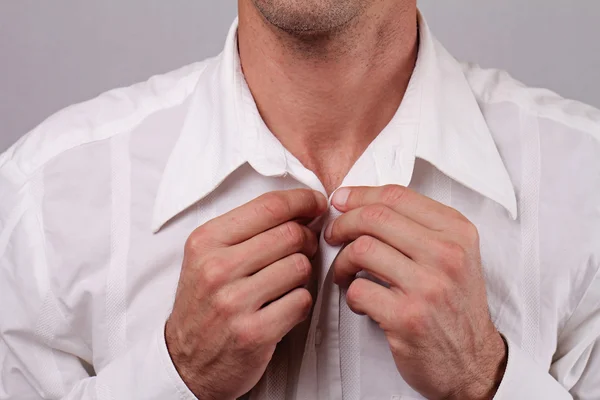 Close up of young man businessman  buttoning up white shirt. Groom preparing for wedding. Perfect white laundry — Zdjęcie stockowe