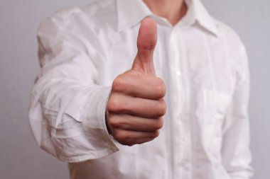 Close up of successfull businessman manager giving thumbs up. Business success concept