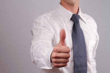 Close up of successfull businessman manager giving thumbs up. Business success concept